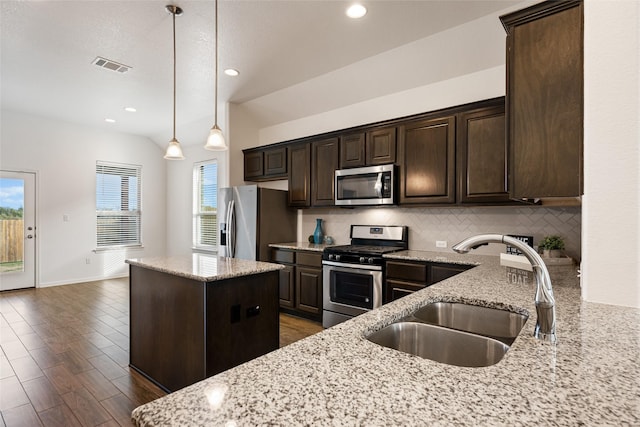 kitchen with light stone counters, sink, and stainless steel appliances