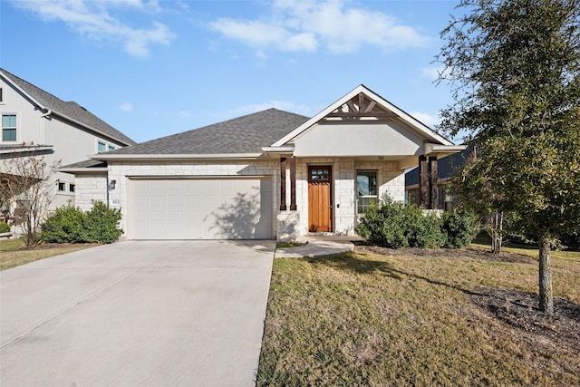 view of front of home with a garage and a front lawn