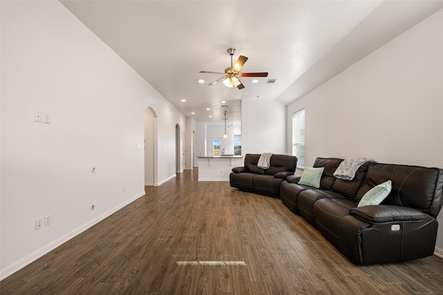 living room with dark hardwood / wood-style floors and ceiling fan