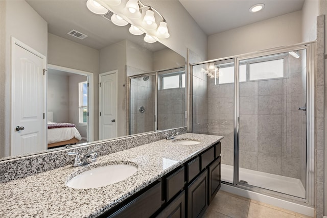 bathroom with tile patterned flooring, vanity, and walk in shower