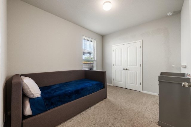 carpeted bedroom with a closet