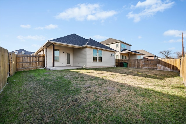 back of property with a patio and a lawn