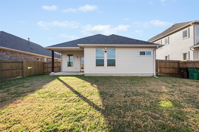 back of property featuring a yard and a patio