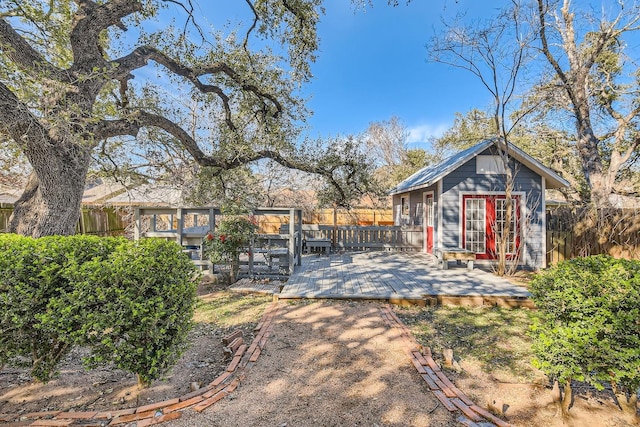 view of yard with a wooden deck and an outdoor structure