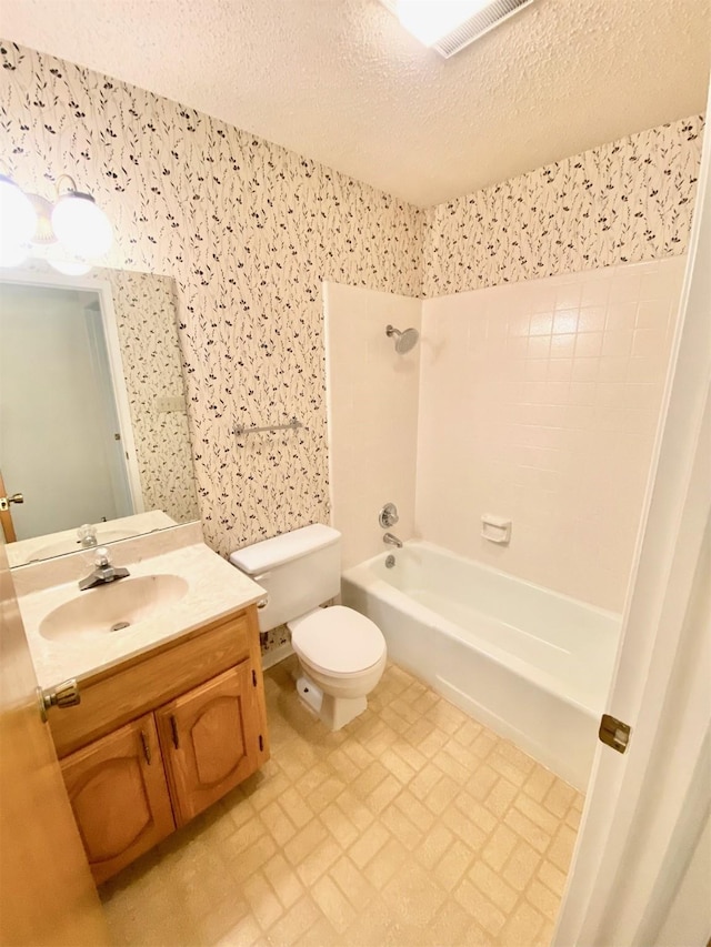 full bathroom featuring a textured ceiling, shower / bathtub combination, toilet, and vanity