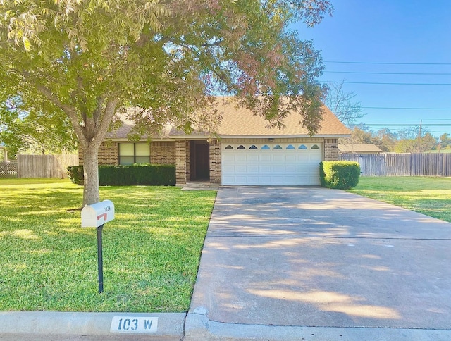 view of front of house with a garage and a front yard