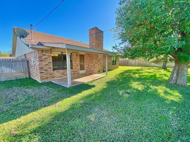 rear view of house featuring a patio and a lawn