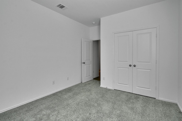 unfurnished bedroom with carpet floors and a closet