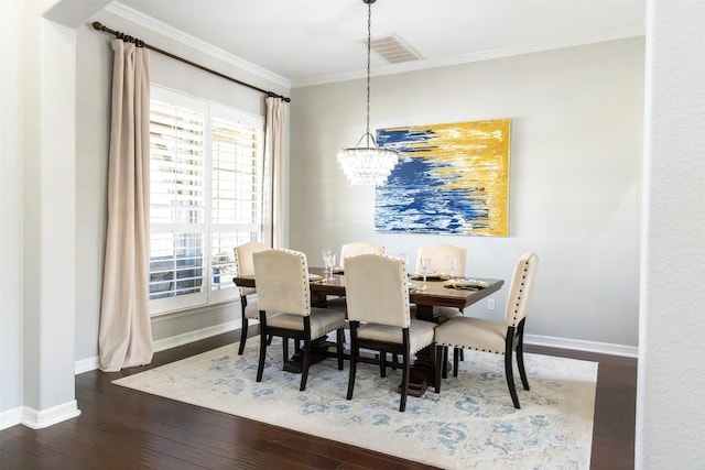 dining area with crown molding, a healthy amount of sunlight, dark hardwood / wood-style flooring, and a notable chandelier