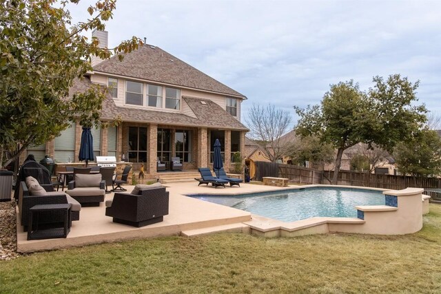 view of swimming pool with a yard, outdoor lounge area, and a patio area