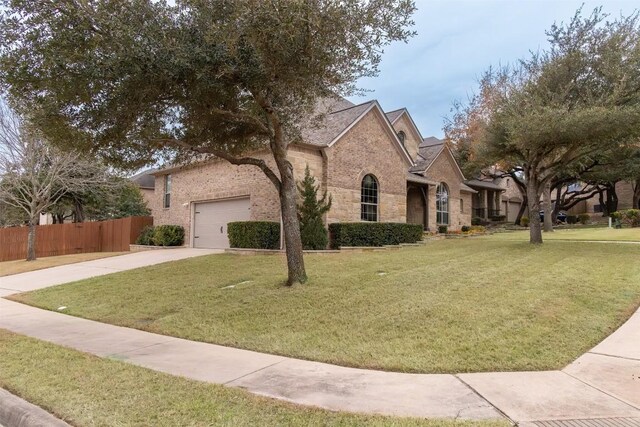 view of front of property with a garage and a front lawn