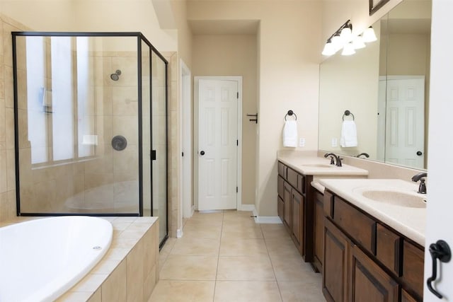 bathroom with vanity, tile patterned floors, and plus walk in shower