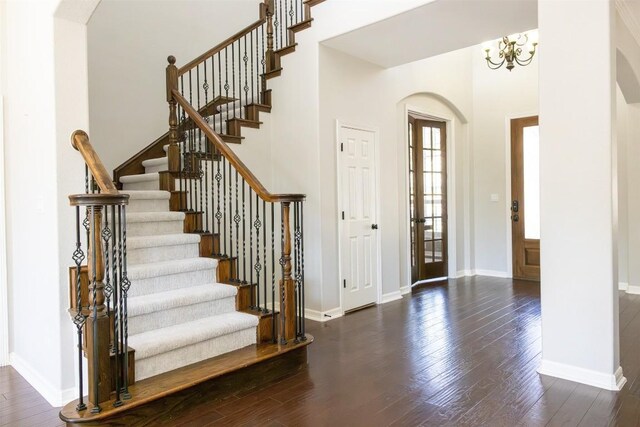 entrance foyer featuring dark hardwood / wood-style floors and a chandelier