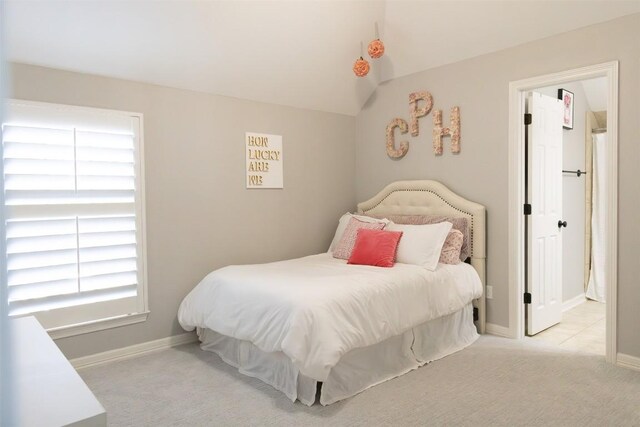 carpeted bedroom with lofted ceiling