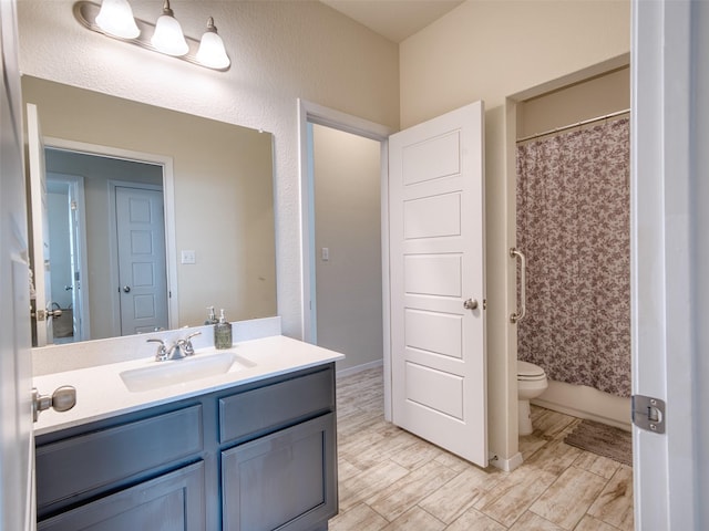 bathroom featuring toilet and vanity