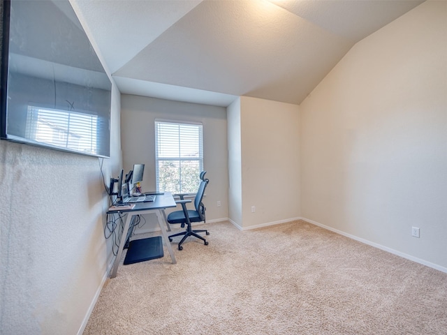 office space featuring light carpet and lofted ceiling