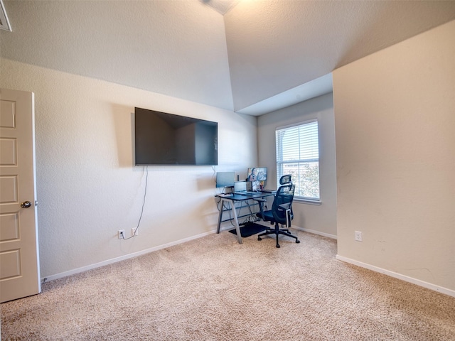 office with carpet floors and vaulted ceiling