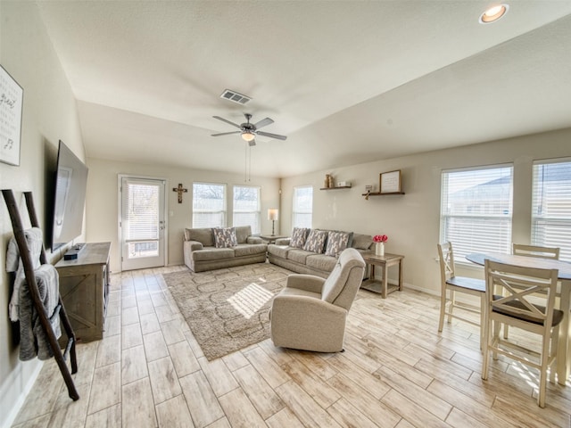 living room with ceiling fan and lofted ceiling