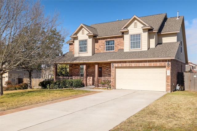 view of front of house featuring a garage, covered porch, and a front lawn