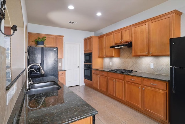 1201 Drake Cv, Leander, TX 78641 - kitchen featuring a sink, black appliances, under cabinet range hood, light tile patterned floors, and backsplash