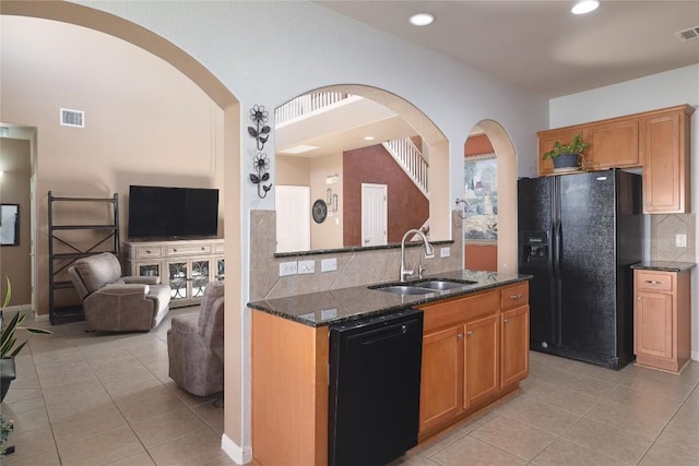 1201 Drake Cv, Leander, TX 78641 - kitchen with black appliances, a sink, light tile patterned floors, dark stone counters, and recessed lighting