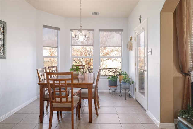 tiled dining area with a chandelier