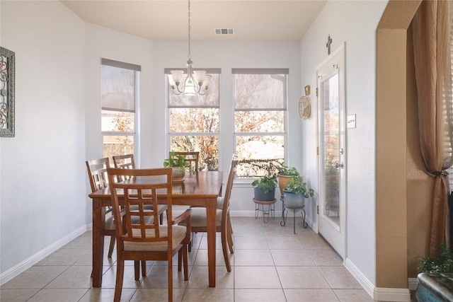 1201 Drake Cv, Leander, TX 78641 - dining room with healthy amount of natural light, a chandelier, light tile patterned flooring, and baseboards