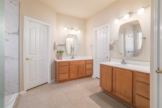 bathroom featuring vanity, a shower, and tile patterned flooring