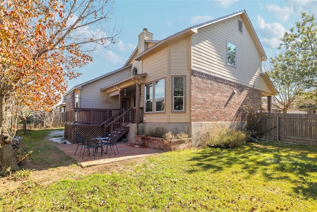 back of property featuring a patio area and a lawn