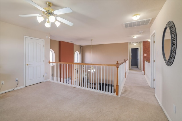 hall featuring light colored carpet