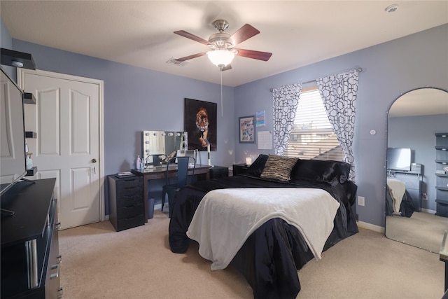 bedroom featuring light colored carpet and ceiling fan