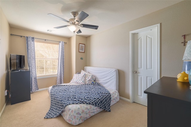 bedroom featuring light carpet and ceiling fan