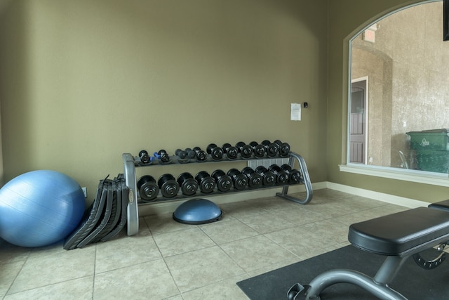 workout room featuring light tile patterned flooring