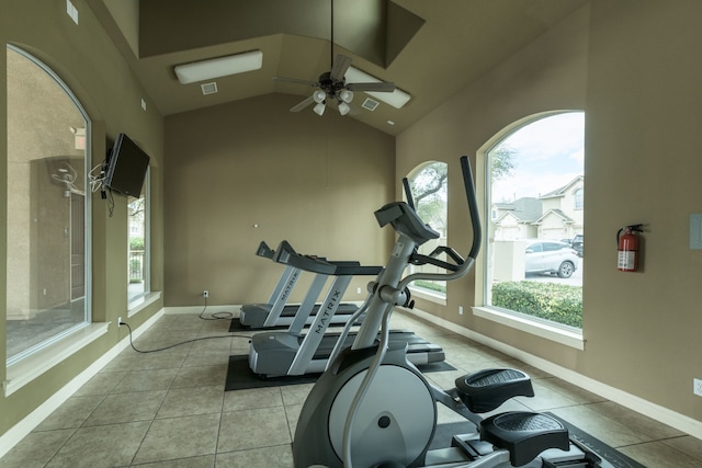 exercise area featuring ceiling fan, high vaulted ceiling, and light tile patterned flooring