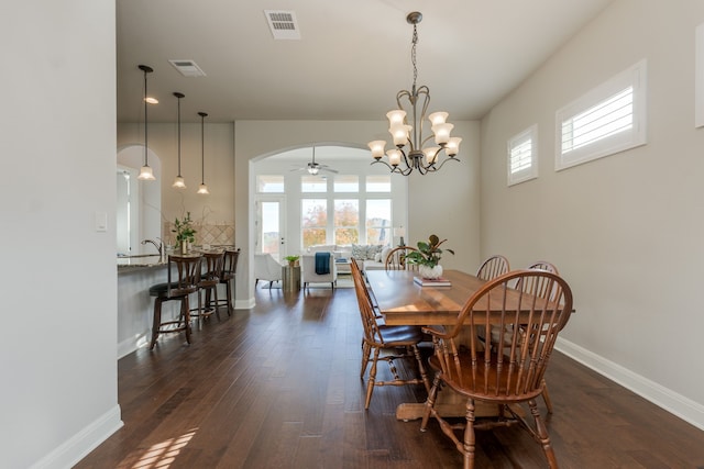 dining room featuring dark wood-type flooring and a chandelier