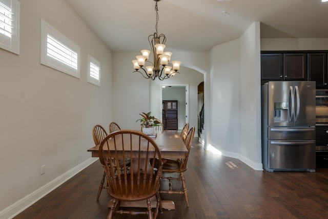 dining room with a chandelier and dark hardwood / wood-style flooring