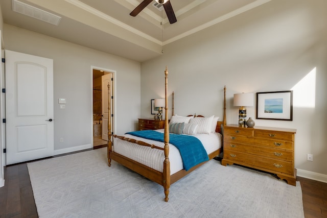 bedroom with wood-type flooring, ensuite bathroom, ceiling fan, and ornamental molding