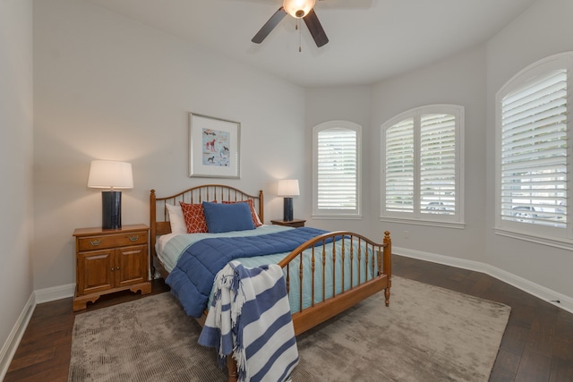 bedroom with dark hardwood / wood-style floors and ceiling fan