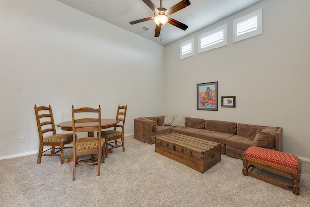 carpeted living room featuring ceiling fan