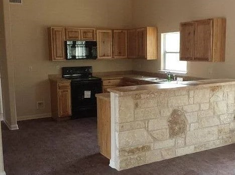 2421 Hornsby, Spring Branch, TX 78070 - kitchen with sink, black appliances, and kitchen peninsula