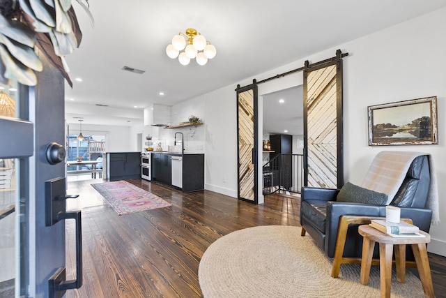 interior space with sink, a barn door, and dark hardwood / wood-style floors