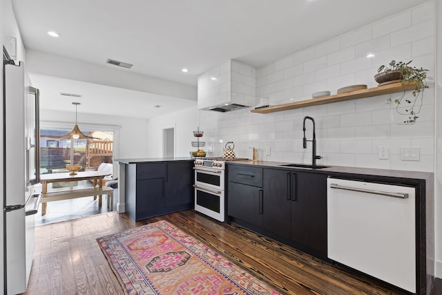 kitchen with white appliances, tasteful backsplash, custom range hood, sink, and kitchen peninsula