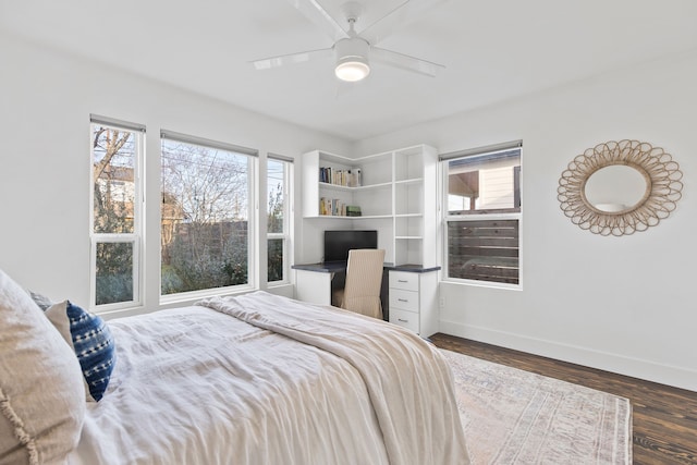 bedroom with ceiling fan and dark hardwood / wood-style flooring