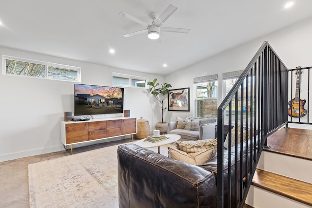 living room featuring ceiling fan and lofted ceiling