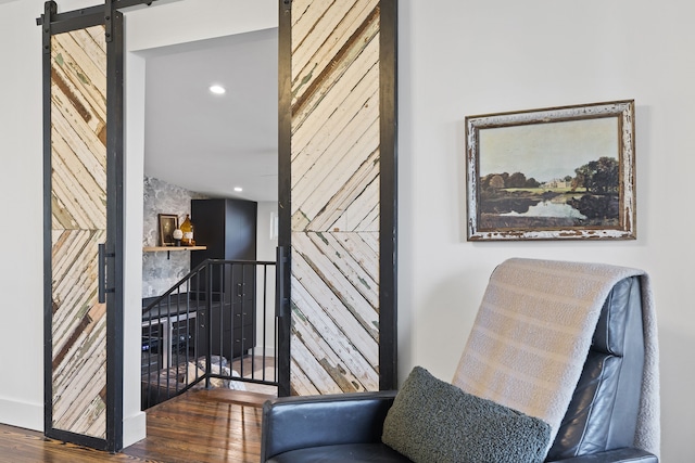 interior space with dark hardwood / wood-style flooring and a barn door