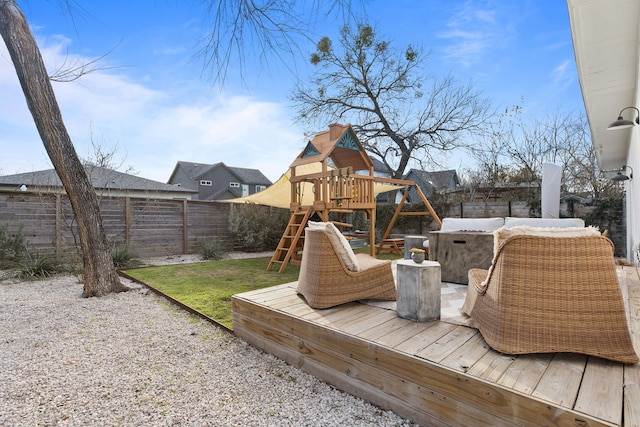 wooden deck featuring a playground