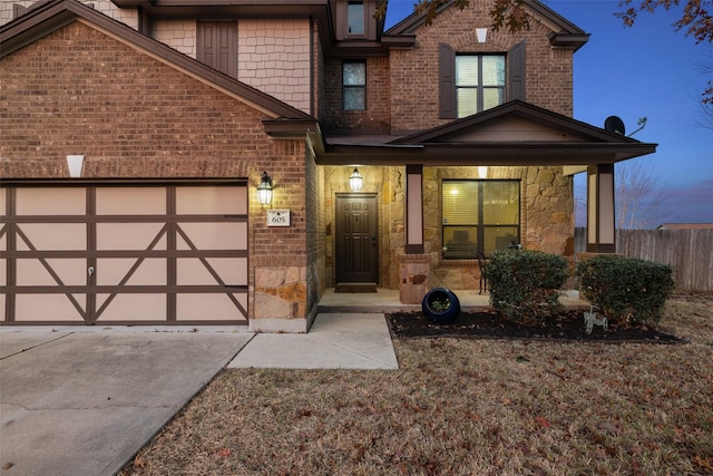 view of front of house featuring a porch and a garage