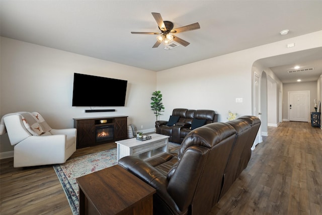 living room with ceiling fan and dark hardwood / wood-style flooring