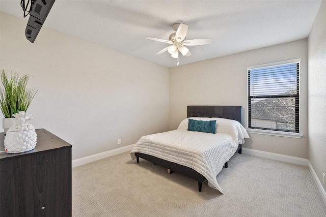 bedroom featuring ceiling fan and light carpet