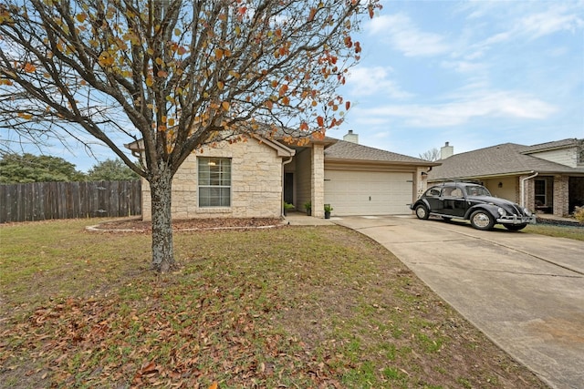 view of front of home with concrete driveway, an attached garage, fence, stone siding, and a front lawn